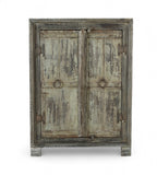 Vintage Indian teak and reclaimed wood side cabinet with weathered greens, greys, and natural patina, featuring ring pulls and a single shelf inside.