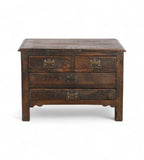 A vintage teak wood side table with brass handles and a compact profile, featuring two larger drawers under two smaller top drawers.