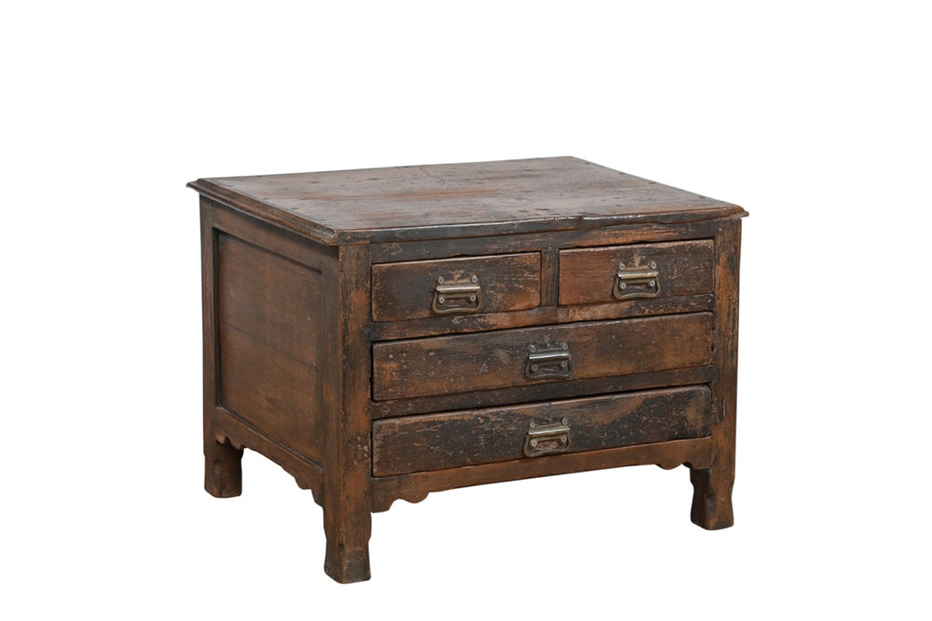 A vintage teak wood side table with brass handles and a compact profile, featuring two larger drawers under two smaller top drawers.