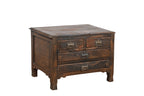 A vintage teak wood side table with brass handles and a compact profile, featuring two larger drawers under two smaller top drawers.