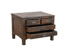 A vintage teak wood side table with brass handles and a compact profile, featuring two larger drawers under two smaller top drawers.