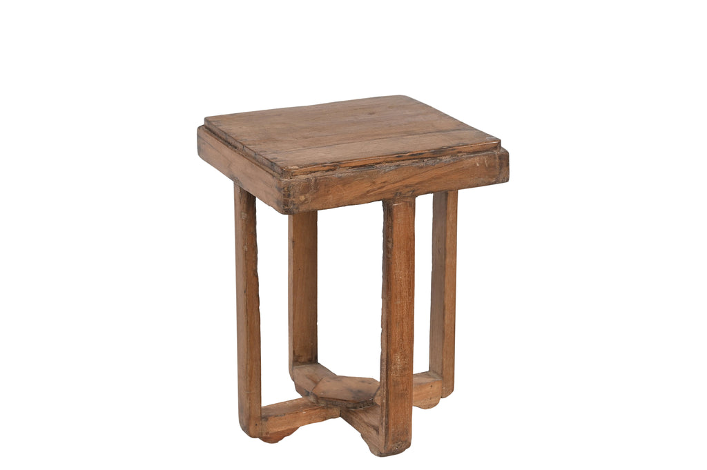 A vintage teak wood side table with a geometric cross brace design at the base.