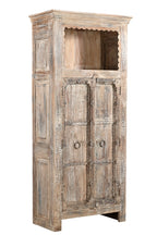 A vintage teak and recycled wood wardrobe with hand-carved details and a lime/multi-coloured patina. It features an upper open section with a scalloped wooden arch and two doors with a visible handle.