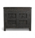 A vintage teak wood side cabinet with iron accents and a carved floral frieze, finished in black.