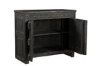 A vintage teak wood side cabinet with iron accents and a carved floral frieze, finished in black.