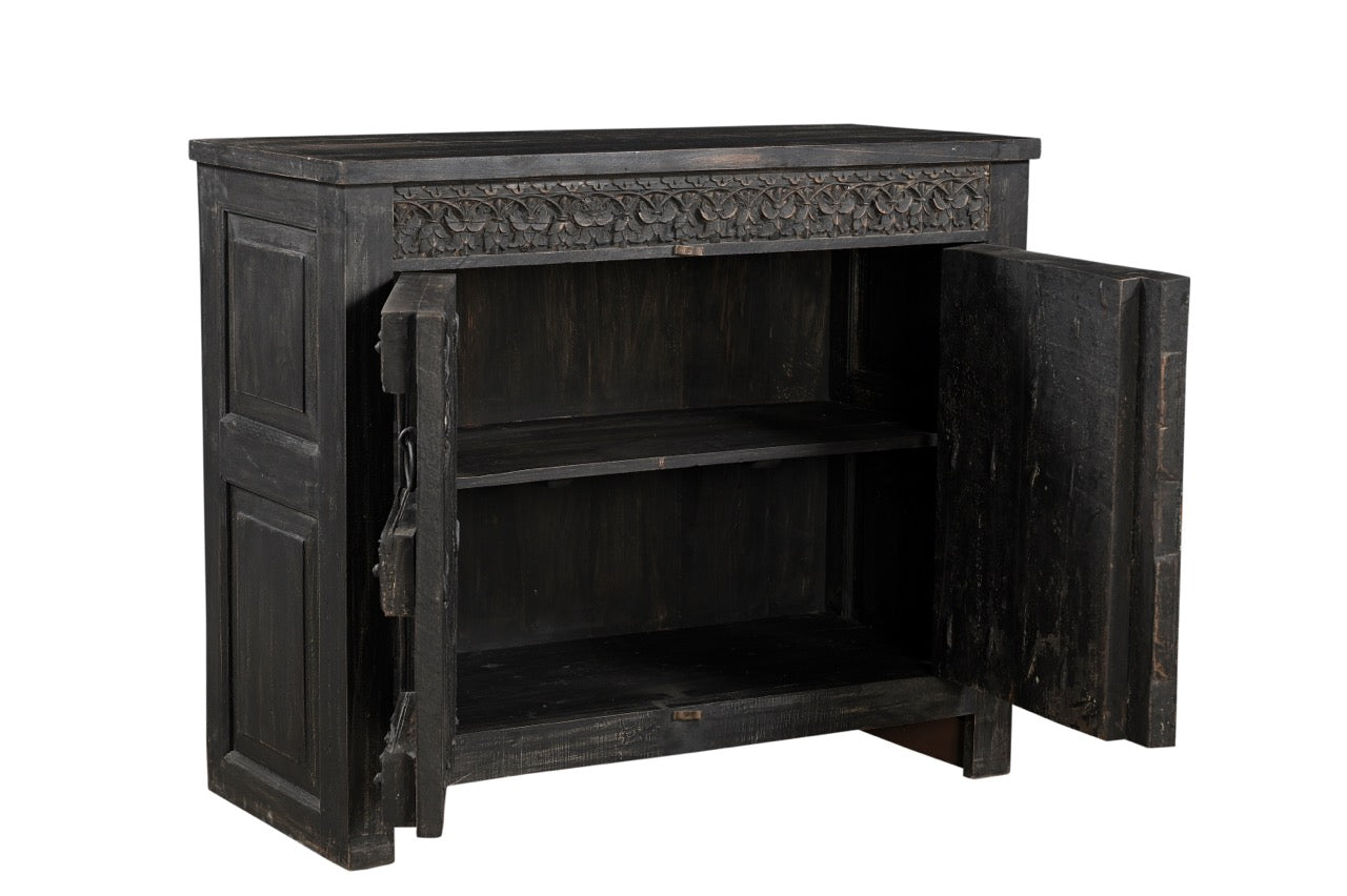 A vintage teak wood side cabinet with iron accents and a carved floral frieze, finished in black.