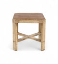 A vintage teak wood side table with off white painted legs and a cross brace detail at the bottom.