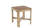A vintage teak wood side table with off white painted legs and a cross brace detail at the bottom.