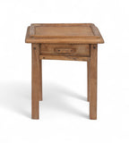 A tiny vintage teak wood side table with a visible drawer, having a natural wood finish and a metal pull ring.