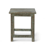 A vintage teak wood side table with a weathered green finish.