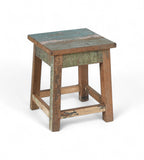 A vintage recycled wood side table with a multicoloured tabletop and brown legs.