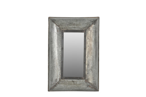 A rectangular wall mirror with a galvanised metal frame featuring visible rivets and a weathered finish.