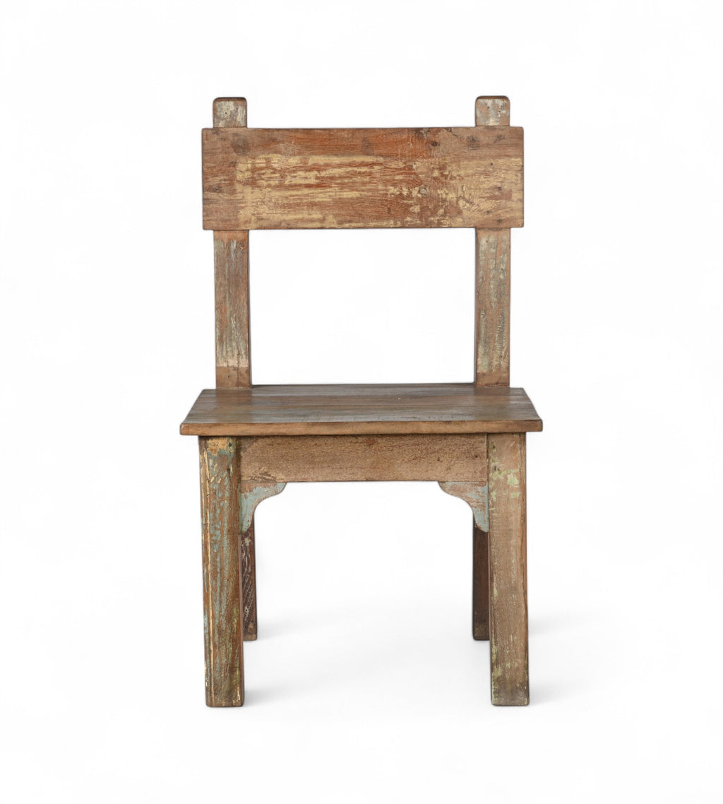A wooden chair with a patina finish, featuring hints of green and yellow paint, with a simple backrest and seat design.