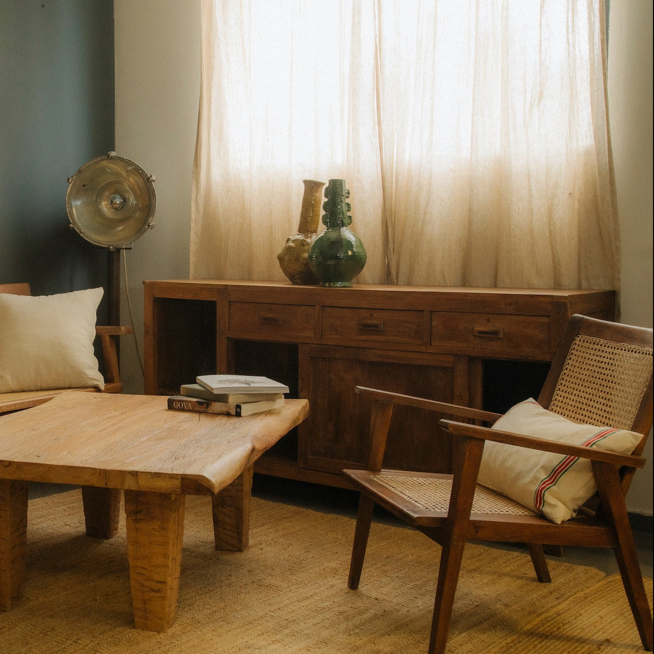 Living room with wooden furniture, including a sofa, table, and chairs.