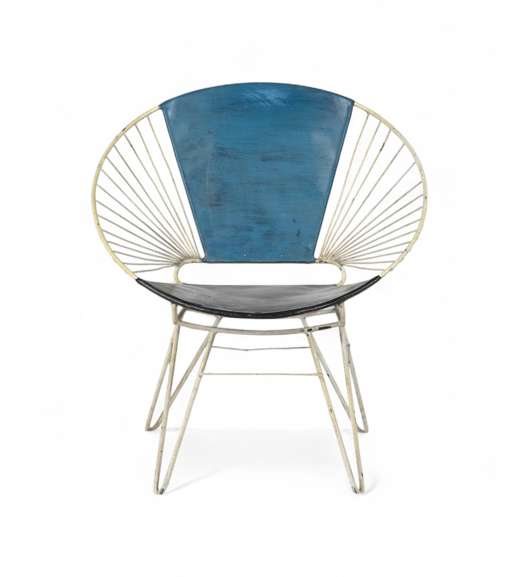 A vintage chair with an iron frame that fans outward and a canvas backrest in ocean blue and a black seat.