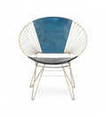 A vintage chair with an iron frame that fans outward and a canvas backrest in ocean blue and a black seat.