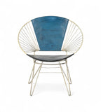 A vintage chair with an iron frame that fans outward and a canvas backrest in ocean blue and a black seat.