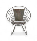 An iron chair with a fan back design and rounded profile, featuring slender legs and a cushioned seat.