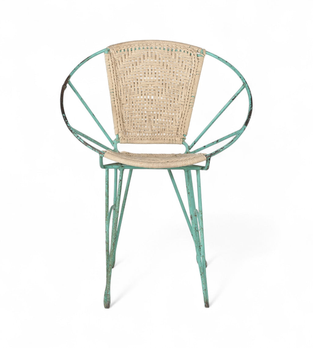 A vintage chair with a green iron frame and natural rope seat and backrest.