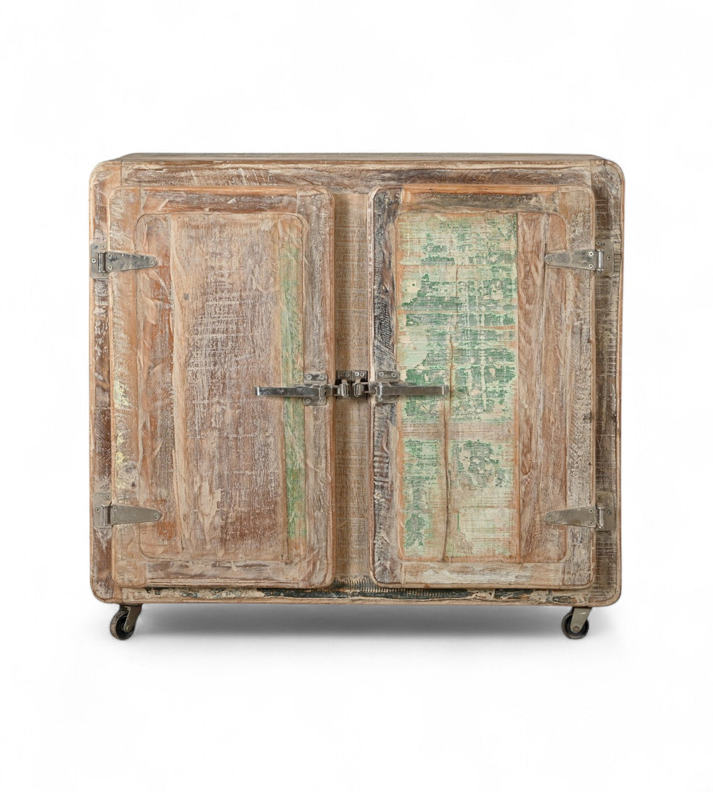 Vintage Indian reclaimed wood side cabinet with iron latches and wheels, featuring a faded multi-coloured patina.