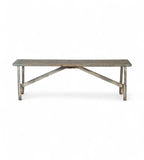 A vintage teak wood and iron bench with a weathered finish and curved leg design.
