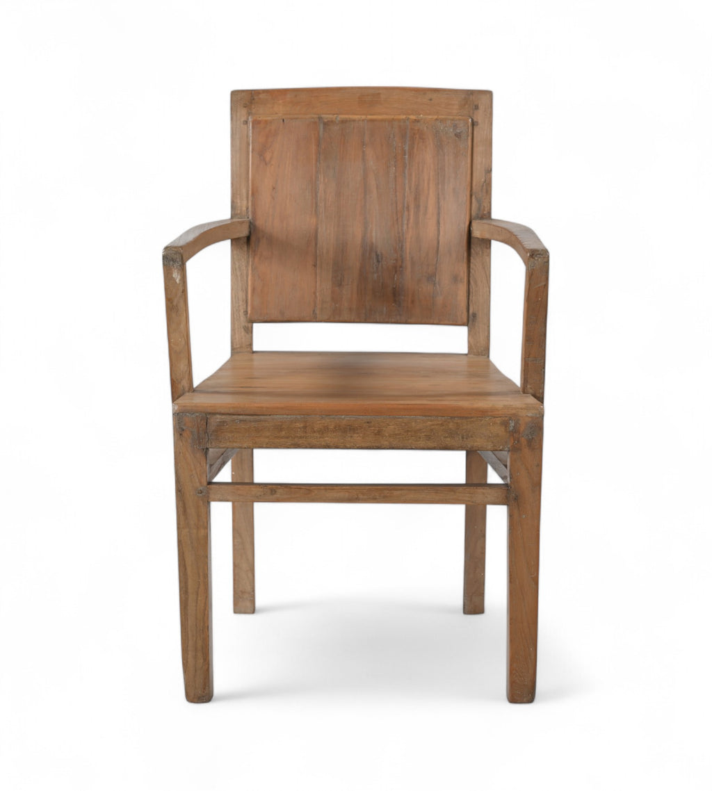 A vintage teak wood armchair with a squared off frame and angled armrests, showing wood grain and warm tones.