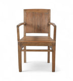 A vintage teak wood armchair with a squared off frame and angled armrests, showing wood grain and warm tones.