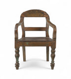 A vintage teak wood arm chair with a gracefully arched back, bowed armrests, and turned legs, with a worn finish and traces of green paint.