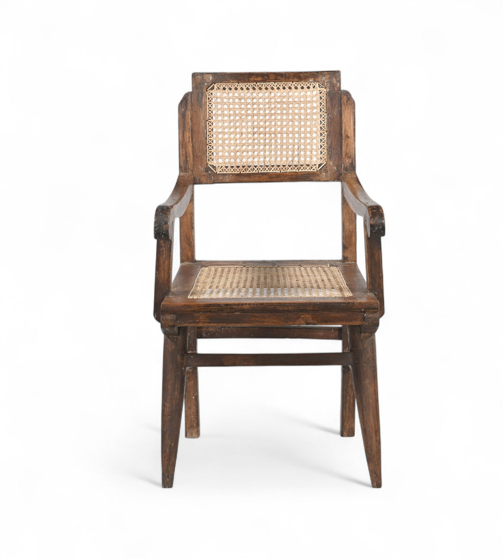 A vintage teak wood armchair with a rattan backrest and seat, featuring gracefully curved armrests.