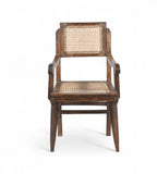 A vintage teak wood armchair with a rattan backrest and seat, featuring gracefully curved armrests.