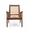 A vintage teak wood armchair with handwoven natural rattan seat and backrest, featuring sculptural arms and a low slung seat.