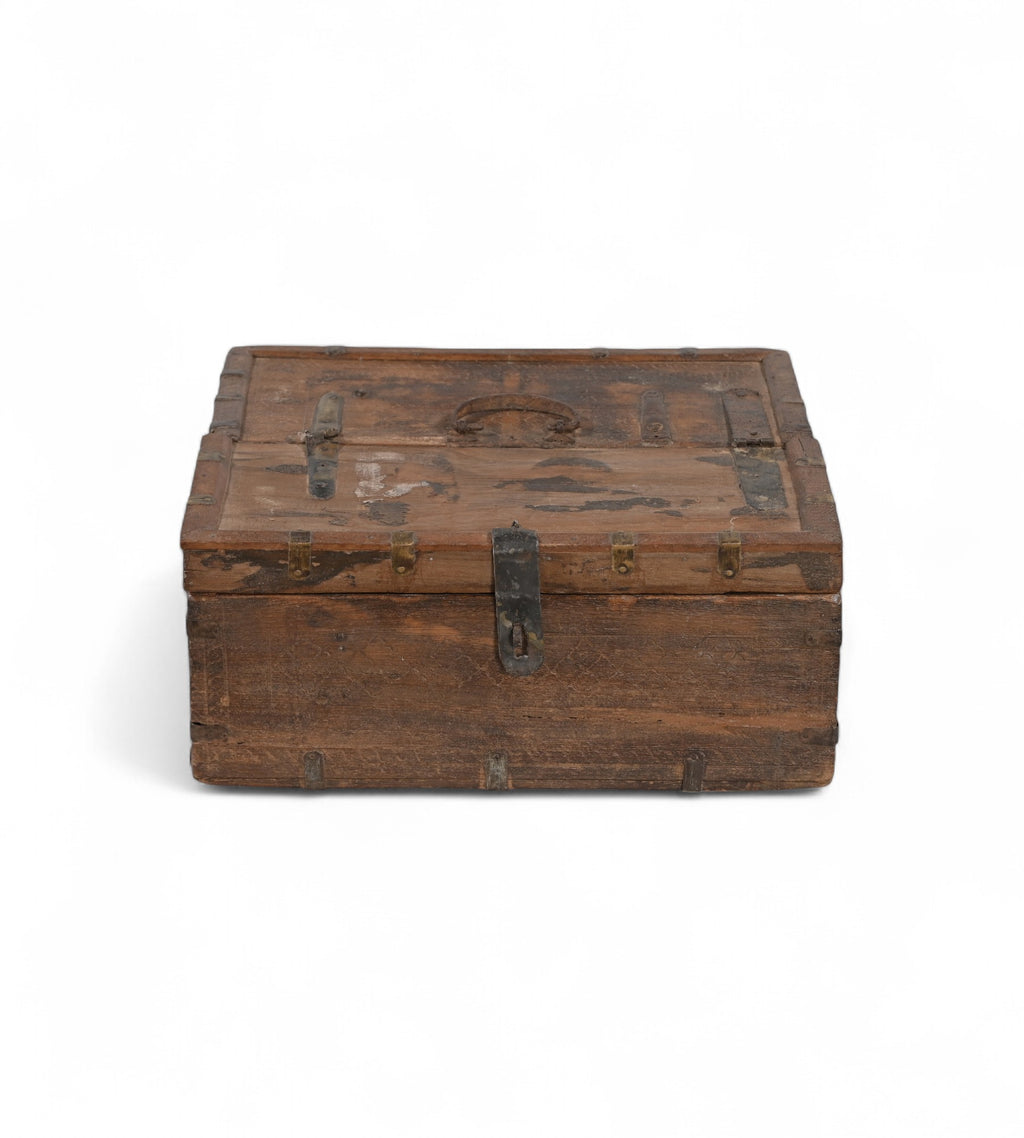 Vintage teak wooden box with metal accents, showing signs of aging and use,