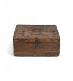 Vintage teak wooden box with metal accents, showing signs of aging and use,